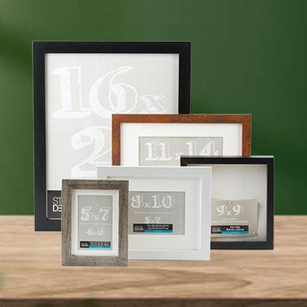 black and brown frames in different sizes on wood table